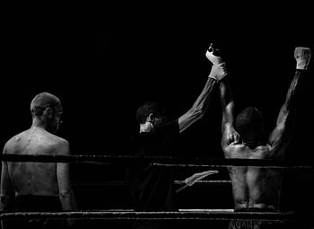 Black and white capturing a victorious boxing moment in the ring. HD wallpaper