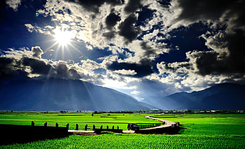 Splendor, rays, sunlight, car, sunbeams, peaceful, beauty, trees, amazing, road, mountains, sun, landscape, beautiful, grass, tree, sunrays, field, green, view, clouds, nature, sky, lovely, village HD wallpaper