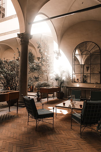 Capture of a stylish courtyard with elegant furnishings in a historical architectural setting. HD phone wallpaper