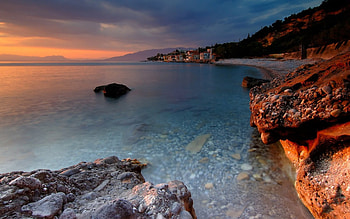 Leading Out to the Lake, blue, dusk, land, quiet, day, brown, water, sunset, smooth, orange, lake, mountain, rock, pink, stone, clouds, nature, sky, cliff HD wallpaper