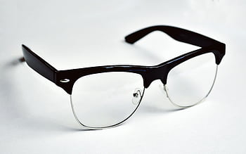 Stylish black wayfarer eyeglasses placed on a clean white background, highlighting fashion and design. HD wallpaper