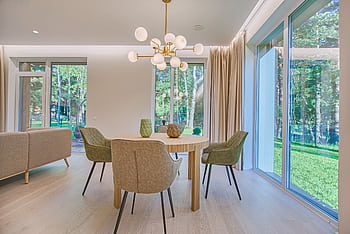 Elegant dining room featuring modern furniture and large windows for natural light. HD wallpaper