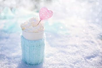 Warm beverage topped with cream in snow, perfect for winter themes. HD wallpaper