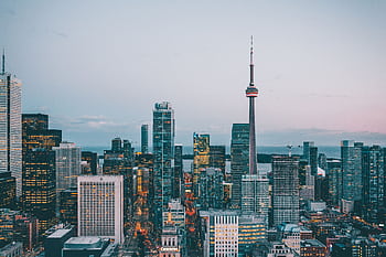A breathtaking view of Toronto's skyline featuring the iconic CN Tower at dusk. HD wallpaper