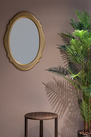 Stylish interior design featuring a decorative mirror and potted plant. HD phone wallpaper