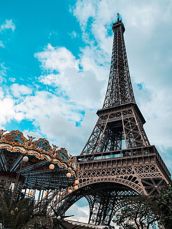 Eiffel Tower in Paris with carousel in foreground under a bright blue sky. HD phone wallpaper
