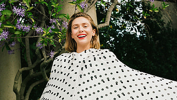 Smiling Actress Elizabeth Olsen Is Wearing Black Dots White Dress Standing In Purple Flowers Tree Background Girls HD wallpaper