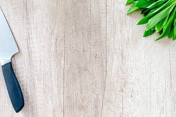Fresh herbs and a chef knife on a wooden surface with copy space. HD wallpaper