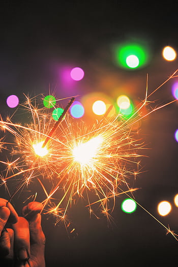 Vibrant of sparklers with colorful bokeh lights, perfect for festive events. HD phone wallpaper