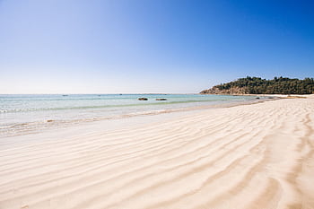 A serene view of a tranquil beach with clear ocean waters and soft sand in Myanmar. HD wallpaper