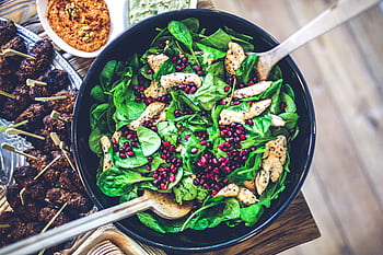 Healthy and vibrant spinach salad with grilled chicken and pomegranate seeds, perfect for a nutritious meal. HD wallpaper