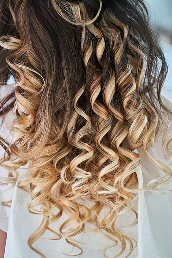 Close-up of elegant blonde curls showcasing detailed hairstyle design. HD phone wallpaper