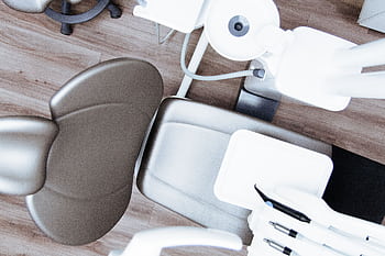 High-angle view of a modern dental chair and equipment setup in a professional clinic. HD wallpaper