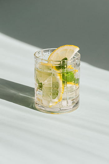 A refreshing lemon mint beverage served in a clear glass on a sunlit surface. HD phone wallpaper