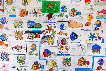 A colorful collage of children's drawings featuring various marine life in vibrant hues. HD wallpaper