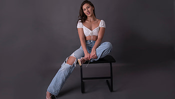 Girl Model Is Sitting On Chair Wearing White Top And Blue Jeans Girls HD wallpaper
