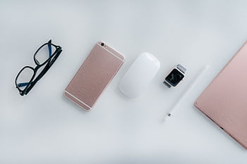 Elegant arrangement of glasses, , watch, mouse, pencil, and tablet on a white surface. HD wallpaper