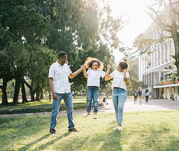 Joyful family enjoying a playful day at the park, embracing love and togetherness under the summer sun. HD wallpaper