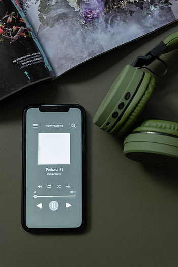 Modern smart and green heads next to a magazine, showcasing technology and lifestyle. HD phone wallpaper