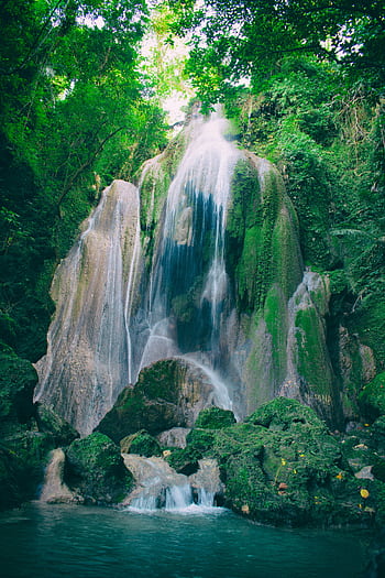 Stunning waterfall cascading over mossy rocks in Bato, Bicol's vibrant jungle setting. HD phone wallpaper