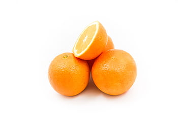 Bright and fresh oranges displayed on a white background, showcasing their vibrant color and juicy texture. HD wallpaper