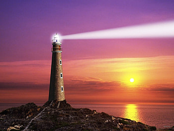 lighthouse, reflection, 3d, lightbeam, rocks, sunset, ocean HD wallpaper