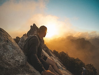 Man enjoying a breathtaking mountain sunset in Waikato, New Zealand, showcasing outdoor adventure and natural beauty. HD wallpaper