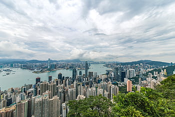 A breathtaking aerial panorama of Hong Kong's iconic skyline with towering skyscrapers and Victoria Harbour. HD wallpaper