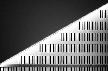 Abstract wall design with geometric patterns and symmetry in urban architecture. HD wallpaper