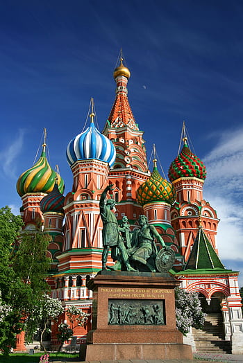Vibrant view of St. Basil's Cathedral's colorful domes and statues on a sunny day in Moscow. HD phone wallpaper