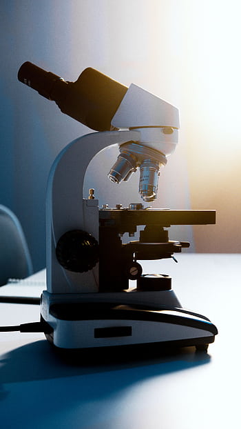 A side view of a modern light microscope on a white laboratory table, bathed in soft natural light. HD phone wallpaper