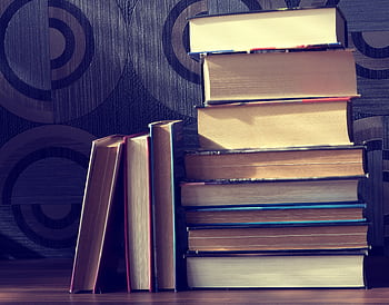 A pile of hardcover books with a vintage vibe, perfect for literature lovers. HD wallpaper