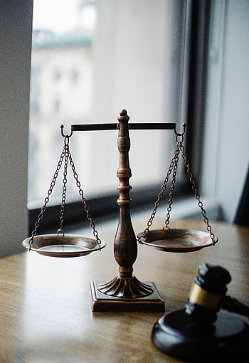 A classic scale of justice and gavel on a wooden desk in an office setting. HD phone wallpaper