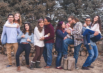 A cheerful family enjoying quality time together outdoors, capturing joyful and loving moments. HD wallpaper