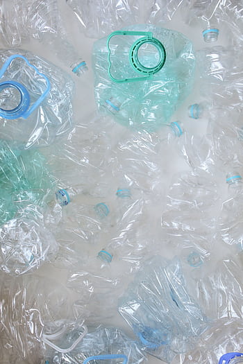 Top view of crumpled plastic bottles, symbolizing recycling and sustainability. HD phone wallpaper
