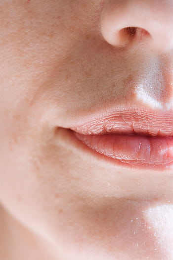 Intimate close-up of feminine lips with soft natural light highlighting the skin texture. HD phone wallpaper