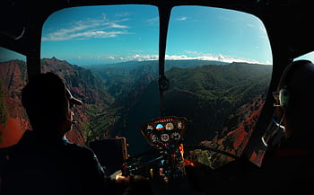 Experience breathtaking aerial views from a helicopter over Kauai's lush valleys and mountains. HD wallpaper