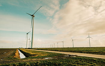 Scenic view of wind turbines in a rural Dutch landscape, generating renewable energy. HD wallpaper