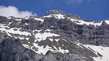 Rock Mountains With Snow Slope During Daytime In Blue Sky Background Nature HD wallpaper