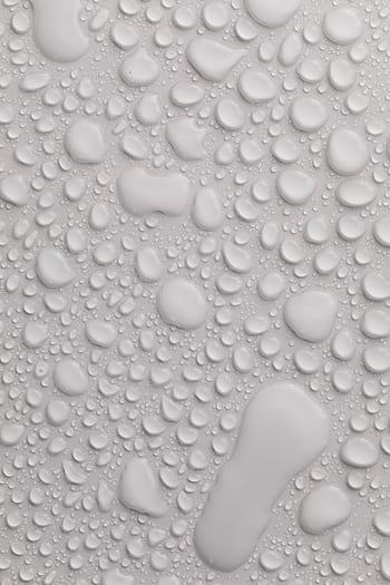 Close-up view of water droplets on a smooth light grey surface, perfect for backgrounds. HD phone wallpaper