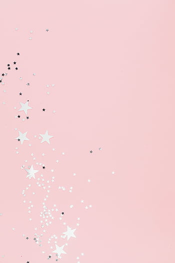 Soft pink pastel background with scattered star-shaped confetti, perfect for festive designs. HD phone wallpaper