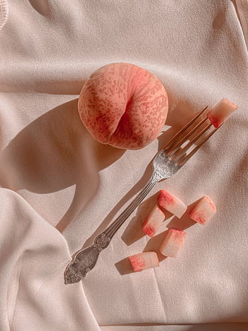 Elegant composition of a ripe peach with slices and shadow on soft fabric, capturing a vintage feel. HD phone wallpaper
