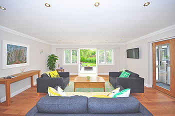 Modern living room with stylish furniture, wooden flooring, and bright decor in a spacious layout. HD wallpaper