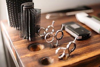 Close-up of barber tools on a stylish wooden counter, perfect for a salon setting. HD wallpaper