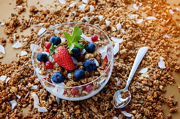 A top view of a healthy granola breakfast with fresh berries and yogurt in București. HD wallpaper