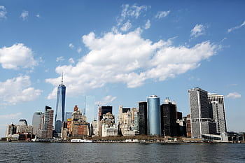 Stunning view of New York City's skyline featuring iconic skyscrapers against a blue sky. HD wallpaper