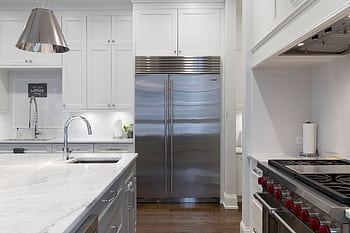 A sleek modern kitchen featuring stainless steel appliances and marble countertops. HD wallpaper