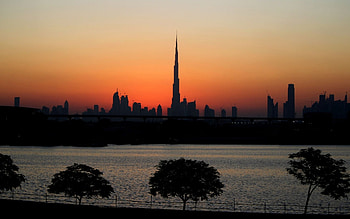 dubai city silhouette at sunset, skyscrapers, city, trees, harbor, silhouette HD wallpaper