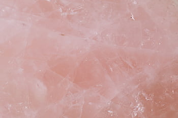 Close-up of rose quartz showcasing its natural pink crystalline texture, perfect for backgrounds. HD wallpaper
