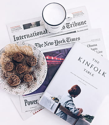 A flat lay of a breakfast scene with coffee, pastries, and newspapers, evoking a relaxed morning vibe. HD phone wallpaper